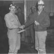 Miner being awarded a watch for service.